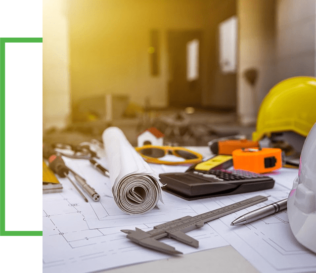 A table with construction tools and papers on it.